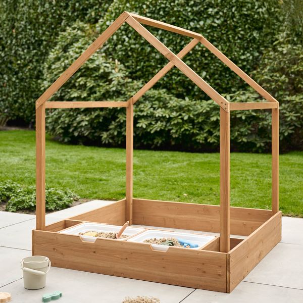 wooden garden playhouse with open windows and sand play area from Petite Amélie